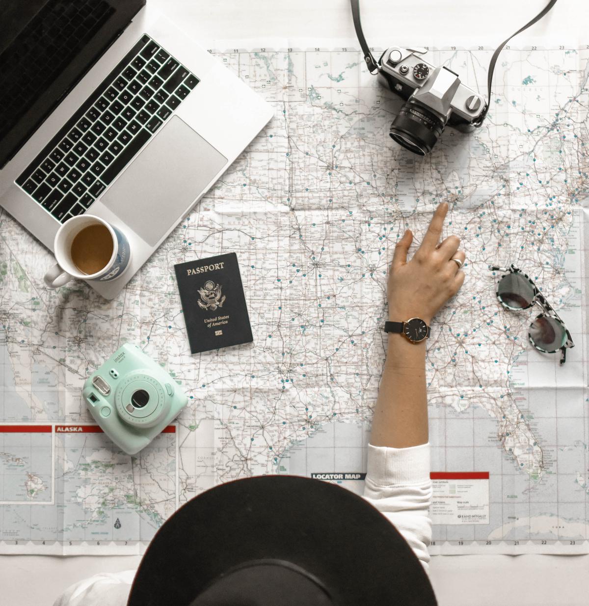 A picture of a person holding a map and looking at a globe, representing the concept of budget travel.