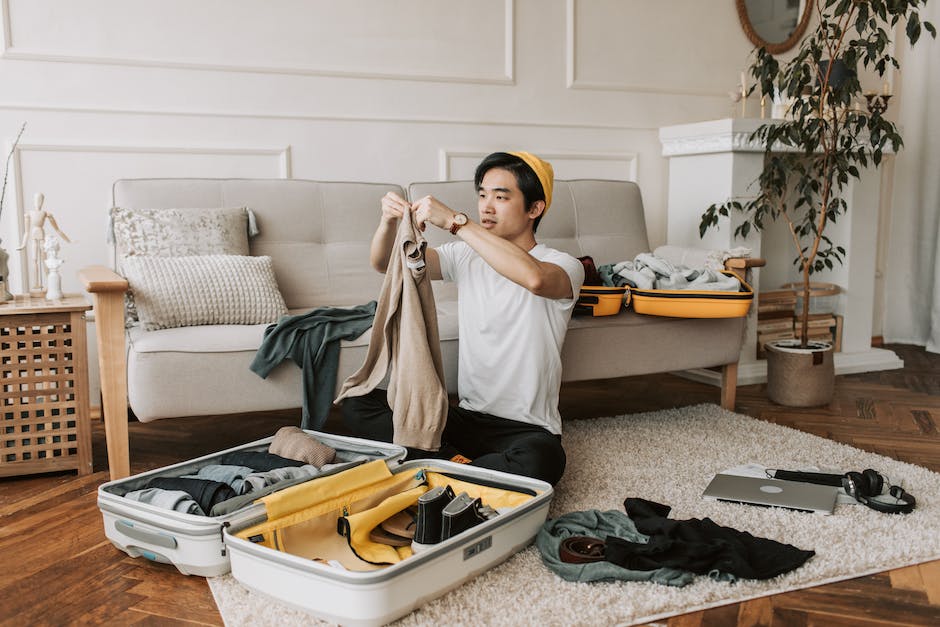 A image of a person packing their suitcase with essential items for a trip.